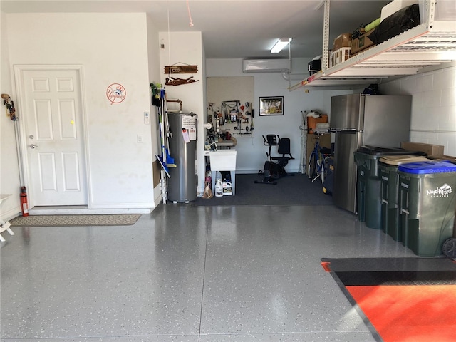 garage featuring gas water heater and stainless steel refrigerator