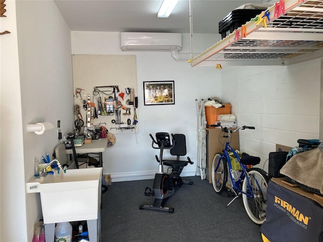 exercise area featuring a workshop area and an AC wall unit