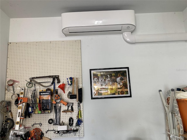 details featuring a wall mounted air conditioner and a workshop area