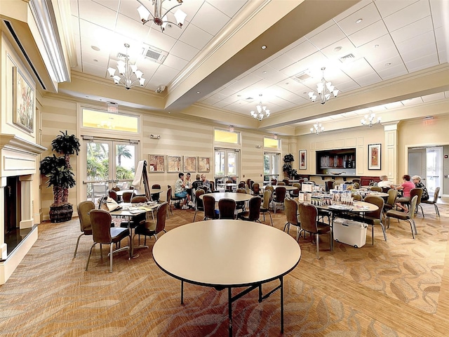 dining room with light hardwood / wood-style flooring and ornamental molding