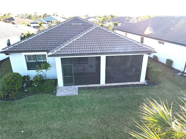 exterior space with a sunroom and a yard