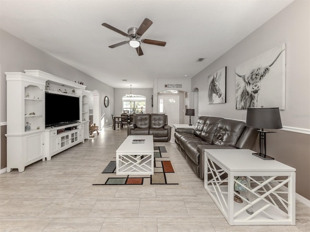 living room featuring ceiling fan and light tile patterned flooring