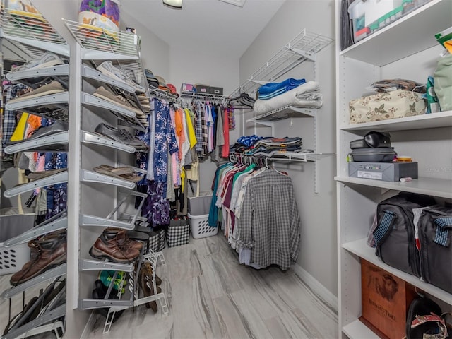 walk in closet with wood-type flooring