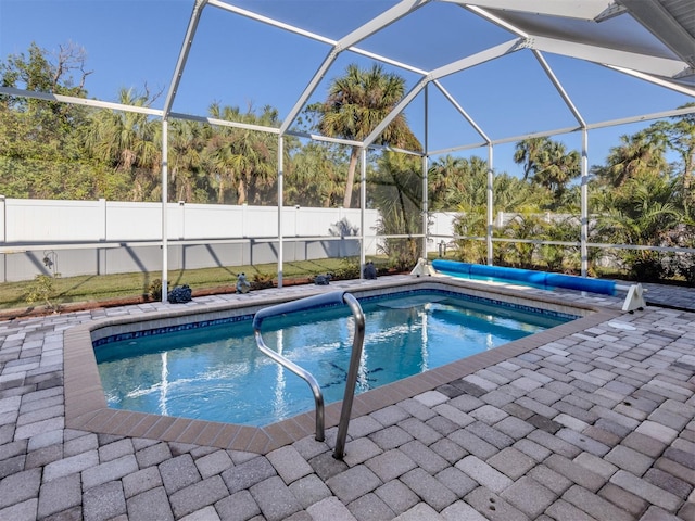 view of swimming pool with a lanai and a patio area