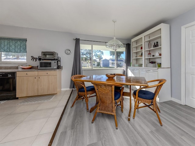 dining space with a chandelier and light hardwood / wood-style floors