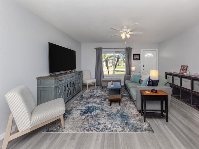 living room with ceiling fan and light hardwood / wood-style floors