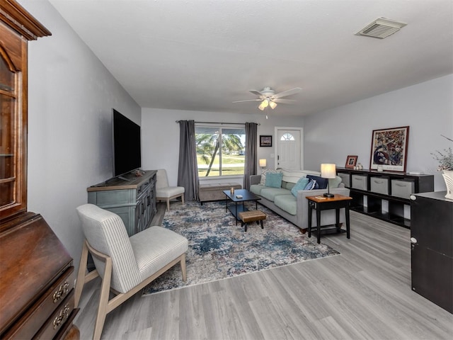 living room with ceiling fan and light wood-type flooring