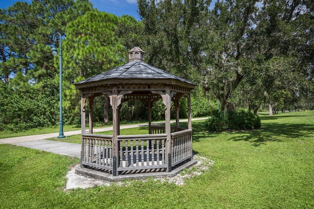 surrounding community with a gazebo and a yard