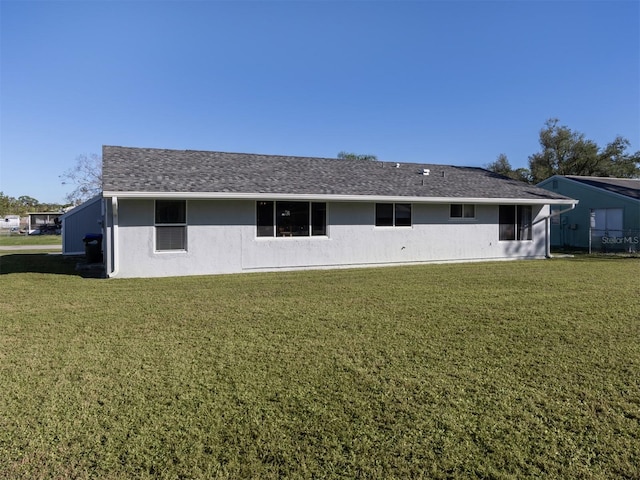 rear view of property with a lawn