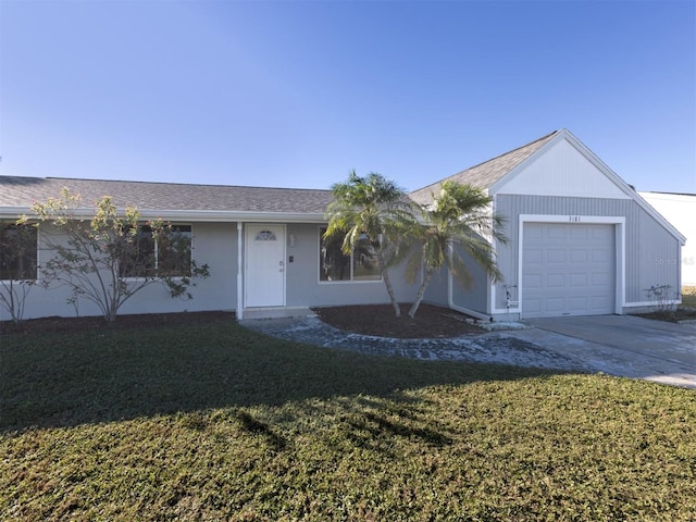 single story home with a garage and a front lawn