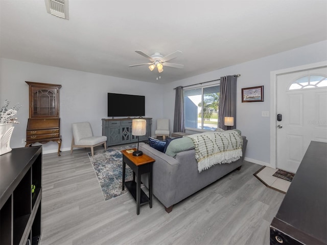 living room with ceiling fan and light hardwood / wood-style flooring