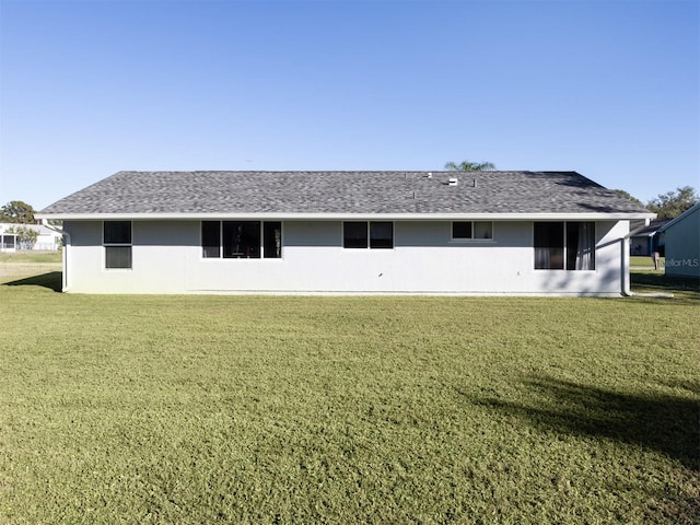 back of property featuring a lawn