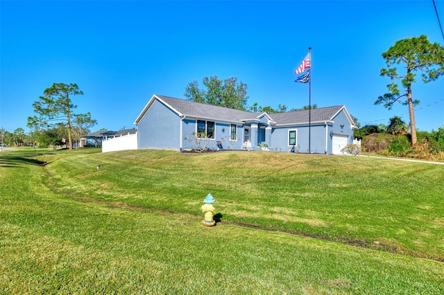 view of front facade featuring a front yard and a garage