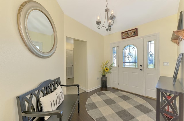 entrance foyer with dark hardwood / wood-style flooring, a chandelier, and lofted ceiling