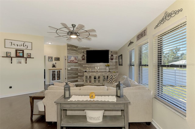 living room featuring ceiling fan, dark hardwood / wood-style floors, and vaulted ceiling