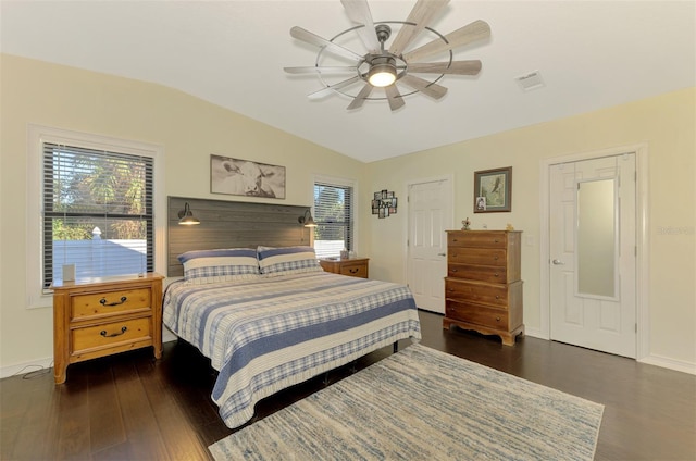 bedroom with ceiling fan, dark hardwood / wood-style floors, and vaulted ceiling