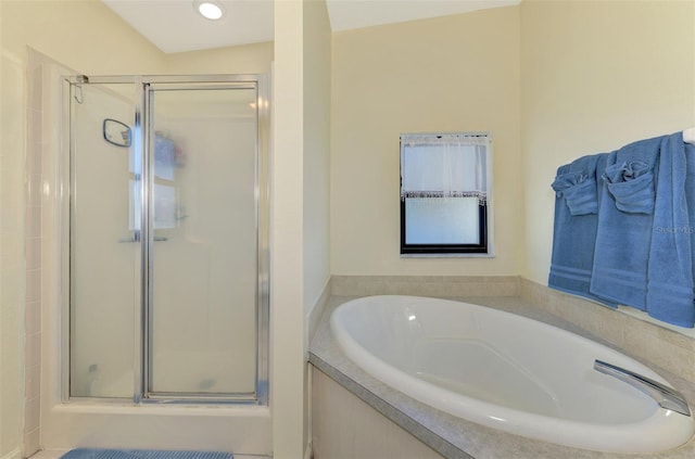 bathroom featuring separate shower and tub and vaulted ceiling