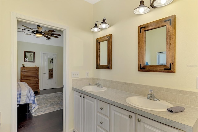 bathroom with hardwood / wood-style floors, ceiling fan, and vanity