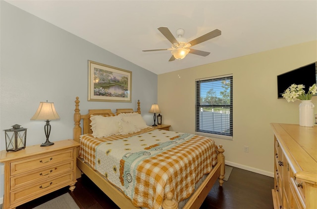 bedroom featuring dark hardwood / wood-style flooring, vaulted ceiling, and ceiling fan