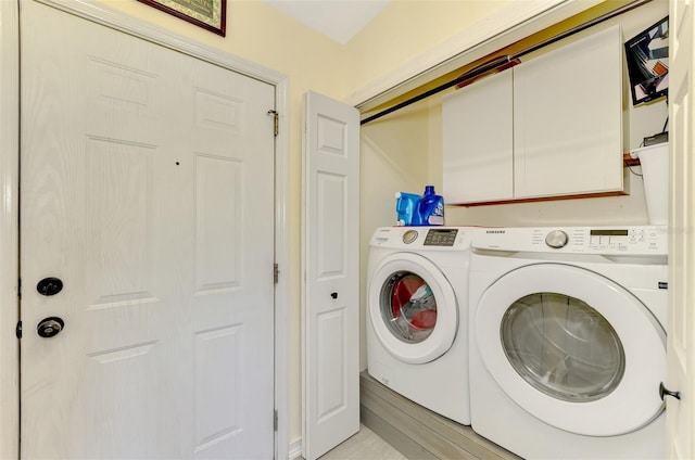 clothes washing area with washing machine and dryer