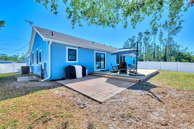 rear view of property with a patio area, a yard, and central air condition unit