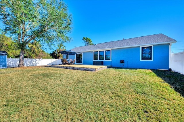 rear view of house featuring a lawn and a patio