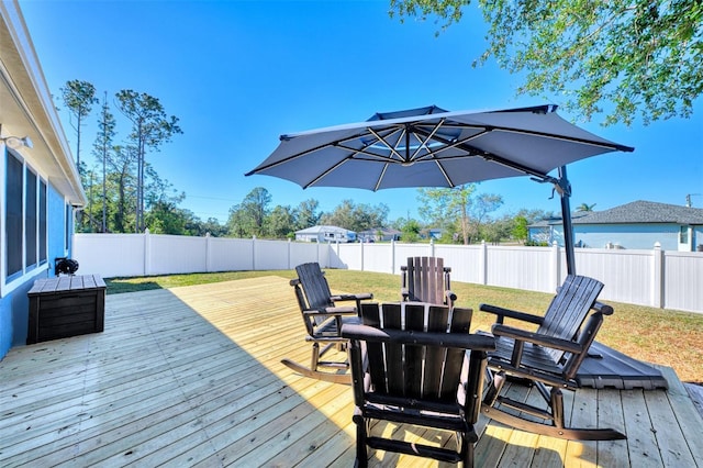 wooden deck featuring a lawn