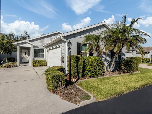 single story home with a garage and a front lawn