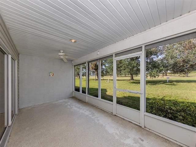 unfurnished sunroom featuring ceiling fan