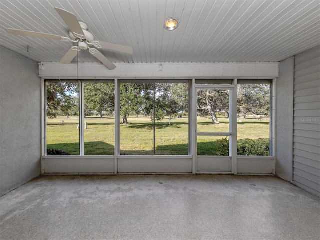 unfurnished sunroom with ceiling fan