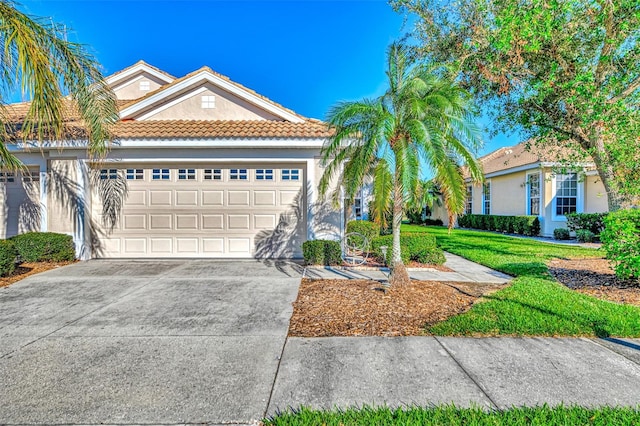 view of front of house featuring a front yard and a garage