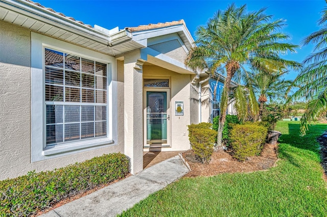 4245 Whispering Oaks Dr, North Port, FL 34287 - entrance to property with stucco siding and a lawn