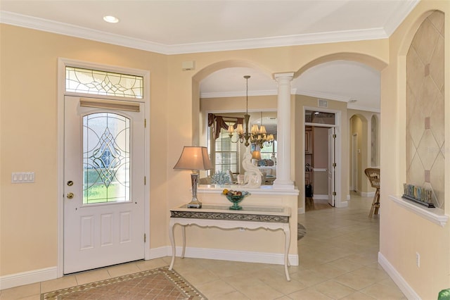 entryway with a chandelier, decorative columns, and crown molding