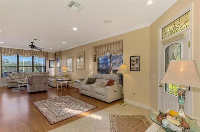 living room with crown molding, hardwood / wood-style floors, and ceiling fan