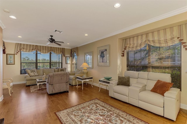 living room featuring hardwood / wood-style floors, ceiling fan, and ornamental molding