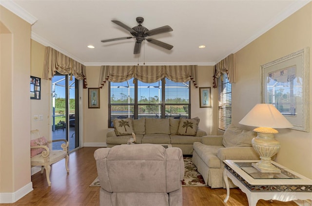 living room with hardwood / wood-style floors, a healthy amount of sunlight, and ornamental molding