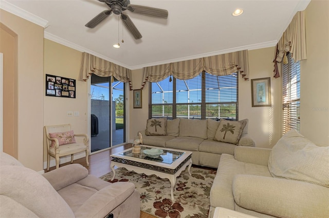 living room featuring a wealth of natural light, crown molding, ceiling fan, and hardwood / wood-style flooring