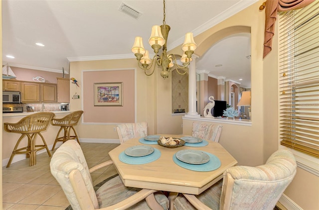 dining space with light tile patterned floors, a chandelier, and ornamental molding