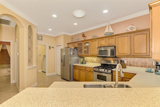 kitchen with appliances with stainless steel finishes, backsplash, light tile patterned floors, and ornamental molding