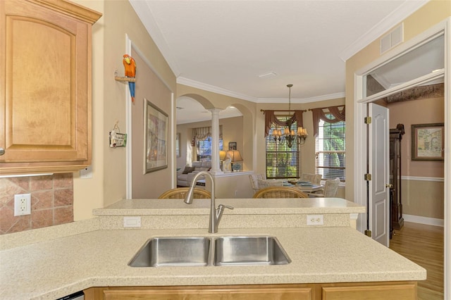 kitchen featuring light brown cabinetry, light hardwood / wood-style flooring, crown molding, and sink