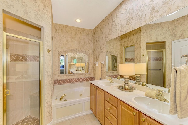 bathroom featuring tile patterned flooring, vanity, and shower with separate bathtub