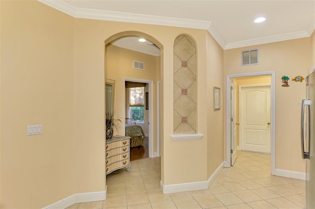 corridor with light tile patterned flooring and ornamental molding