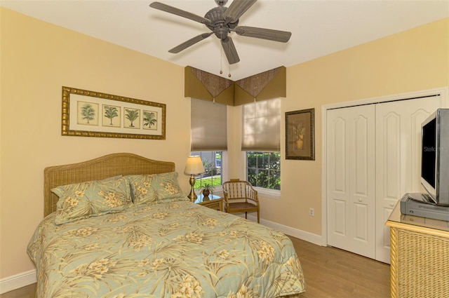 bedroom with wood-type flooring, a closet, and ceiling fan