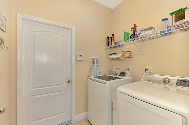 4245 Whispering Oaks Dr, North Port, FL 34287 - laundry area with washer and clothes dryer and baseboards