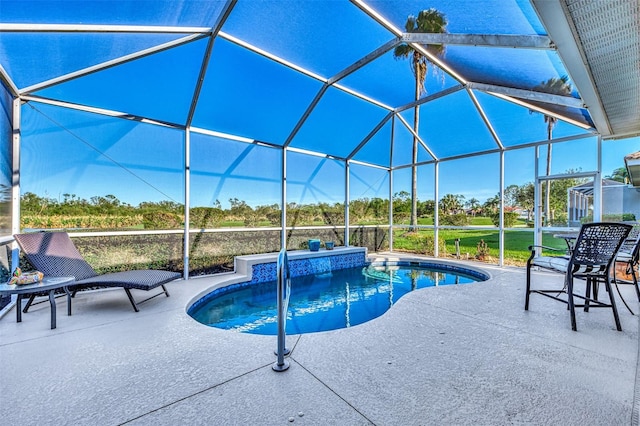 view of swimming pool featuring a patio area and a lanai