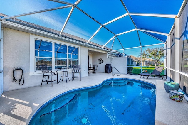 view of swimming pool with a patio area and a lanai