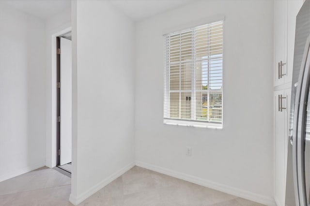 spare room featuring light tile patterned floors