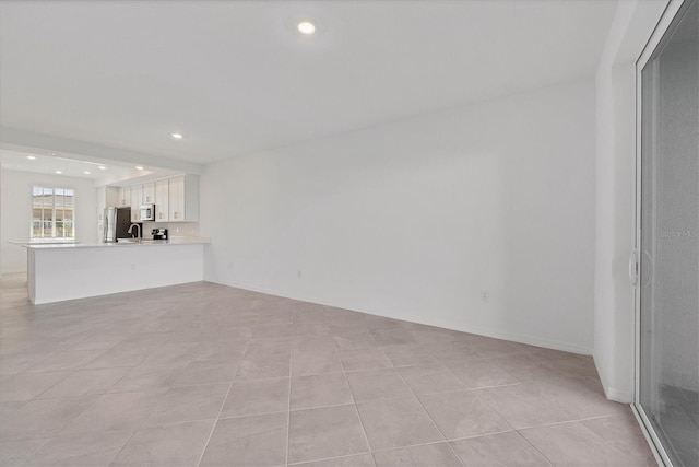 unfurnished living room featuring light tile patterned flooring