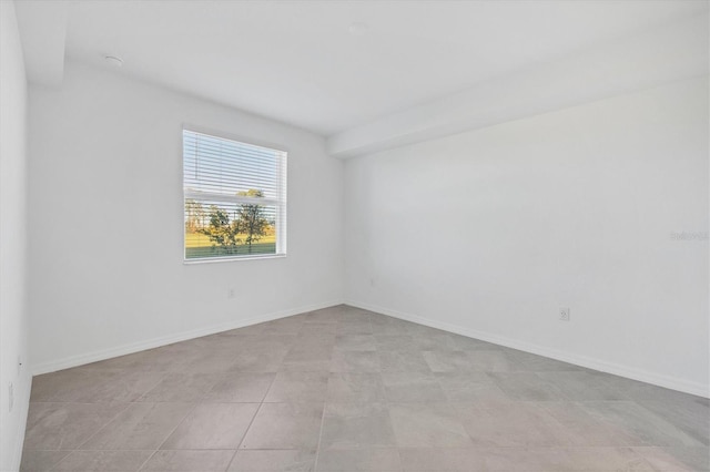 spare room featuring light tile patterned floors