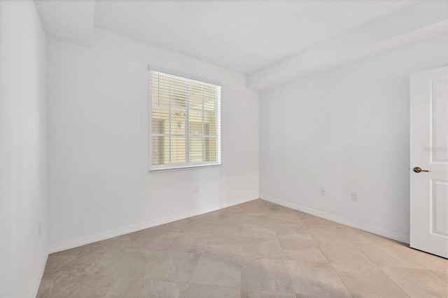 unfurnished room featuring light tile patterned flooring